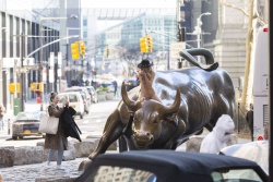 Nude woman charging bull