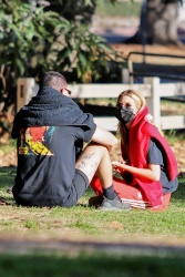 Stella Maxwell - chats with a friend while enjoying some fresh air and coffee at the park in Los Angeles, California | 01/09/2021