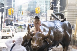 Nude woman charging bull