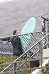 Leighton Meester - Shows off her fit physique in a black wetsuit while catching waves in Malibu, November 5, 2021