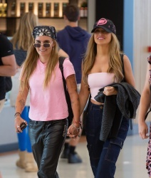 Chrishell Stause & G Flip - Are all smiles as they arrive at Adelaide airport hand in hand, January 5, 2023