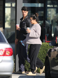 Gina Rodriguez - Shows off her baby bump while out on a coffee run with her husband Joe LoCicero in Los Angeles, December 21, 2022