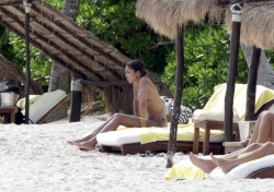 Laura Harrier - Looks stunning in a tiny leopard print bikini as she kisses her boyfriend on the beach in Mexico, November 16, 2021