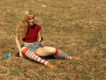 Blonde in a grassy field toy fucks her pussy