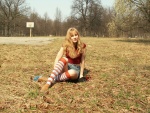 Blonde in a grassy field toy fucks her pussy