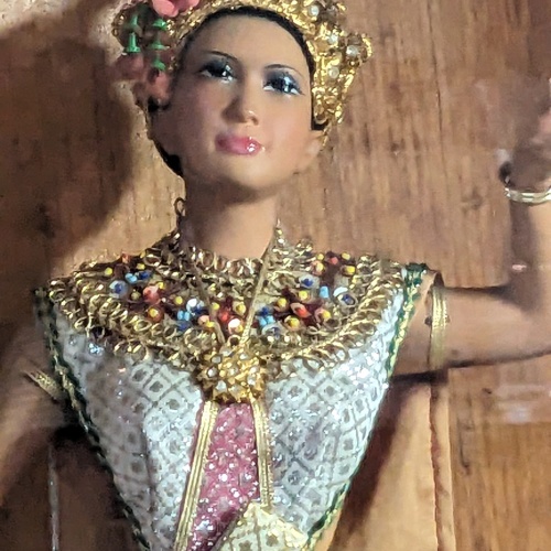 Close up of one of the thai dolls, showing its detail.