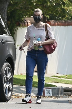 Milla Jovovich - Carries a juice drink and sippy cup after visiting a friend in Los Feliz, September 16, 2020