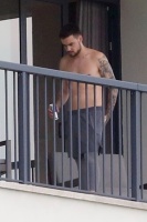 Liam Payne - enjoys a cigarette with his morning coffee while chatting shirtless with a friend in Rio de Janeiro, Brazil - June 5, 2018