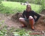 Nerdy chick squatting in the dirt and pissing