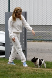 Reese Witherspoon - Scoops up her little dog Minnie Pearl after taking her for a walk in Los Angeles, May 10, 2021